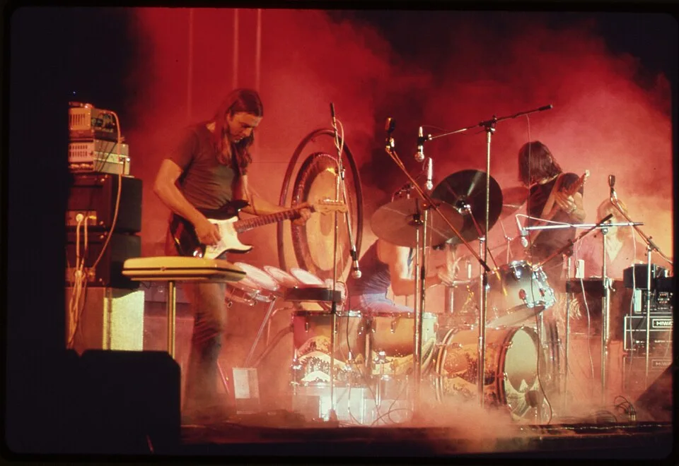 Pink Floyd on stage in red light and smoke, 1973
